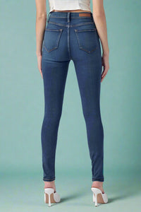 Blue jeans worn by a person on a blue background