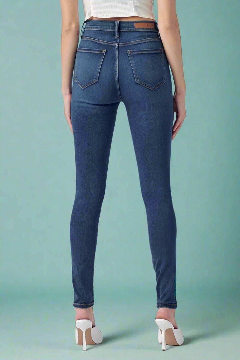 Blue jeans worn by a person on a blue background