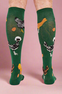 Green knee-high socks with chicken designs on a white background