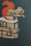 Embroidered design of a dragon on a dark fabric background