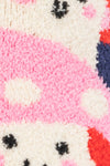 Close-up of a knitted fabric with a pattern resembling a face.