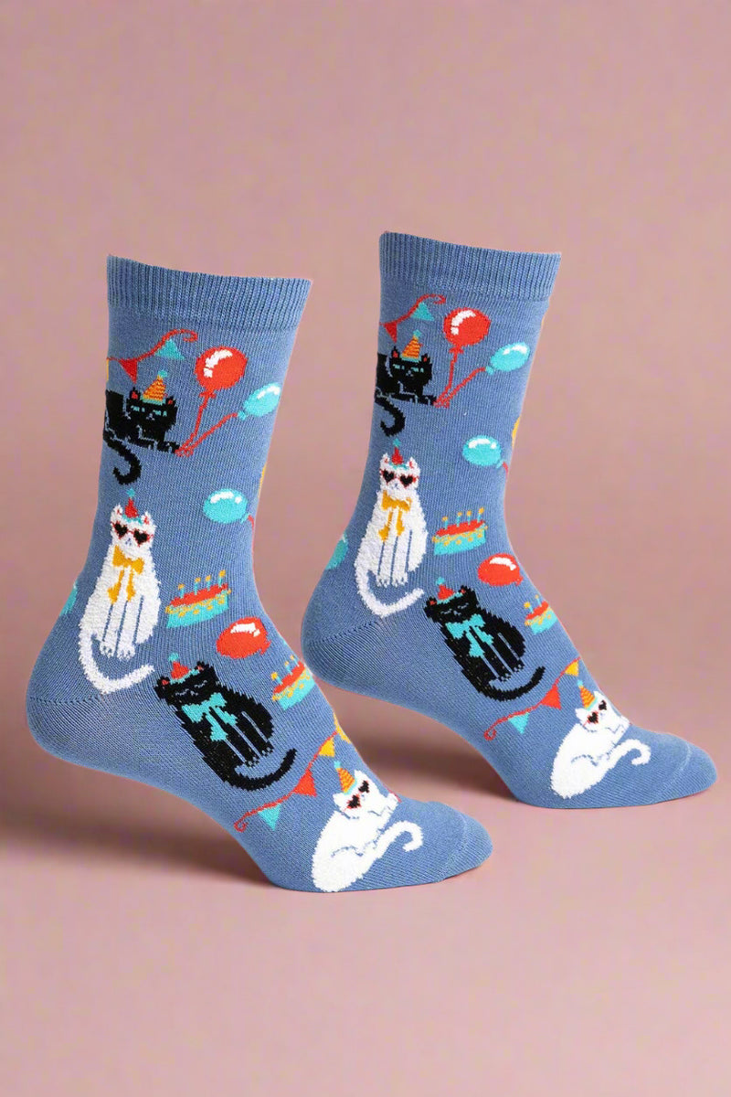 Blue socks with cat and balloon designs on a white background