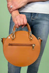 Model is carrying a small circle purse with braided handle, gold keychain and exterior pockets. Includes a cross body strap. 