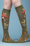 Knee-high socks with forest animal pattern worn by a person on a white background