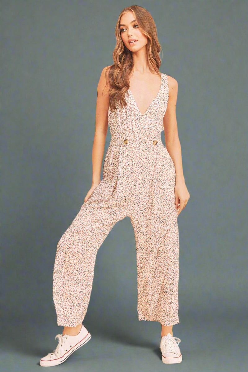 Woman wearing a sparkly jumpsuit on a beige background