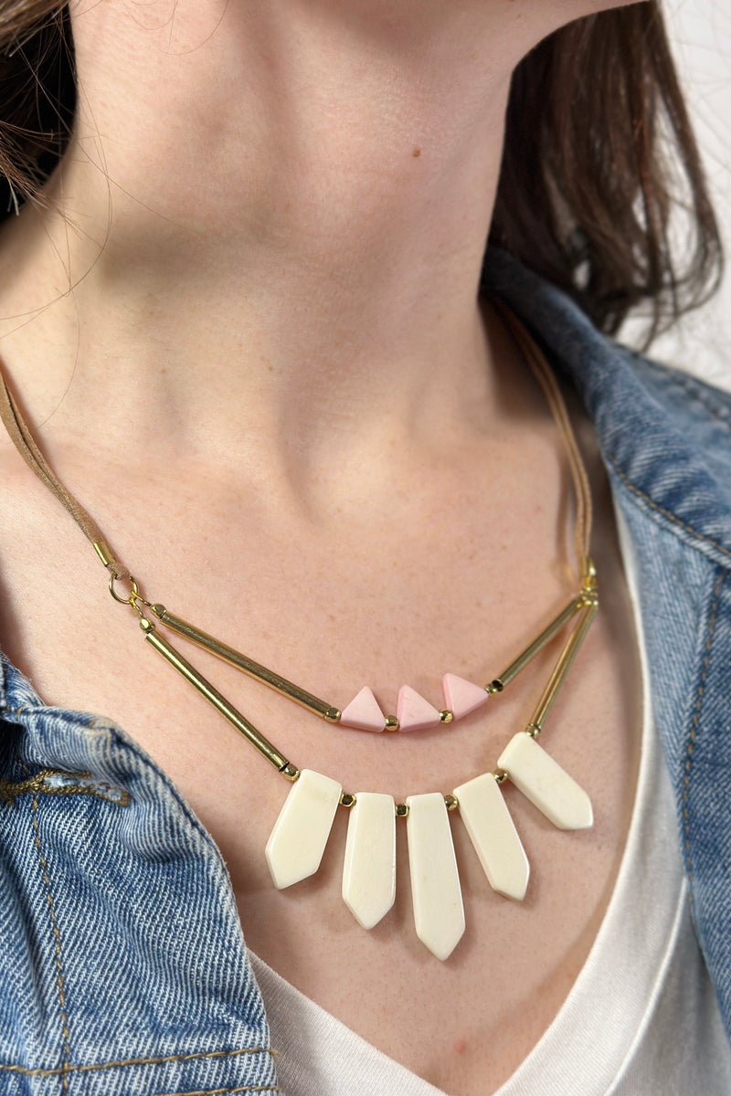 Model is wearing a fair trade necklace with bone statement pieces. 
