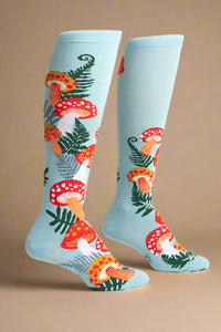 Colorful mushroom-patterned socks on a light blue background