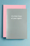 A minimalist style greeting card in a sage green with white text that read ‘It’s that time of year again.’