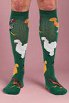Green knee-high socks with chicken pattern worn by a person on a white background