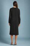 Black dress worn by a person on a plain background