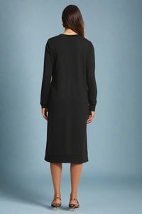 Black dress worn by a person on a plain background