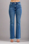Flared blue jeans with distressed hem on a plain background.