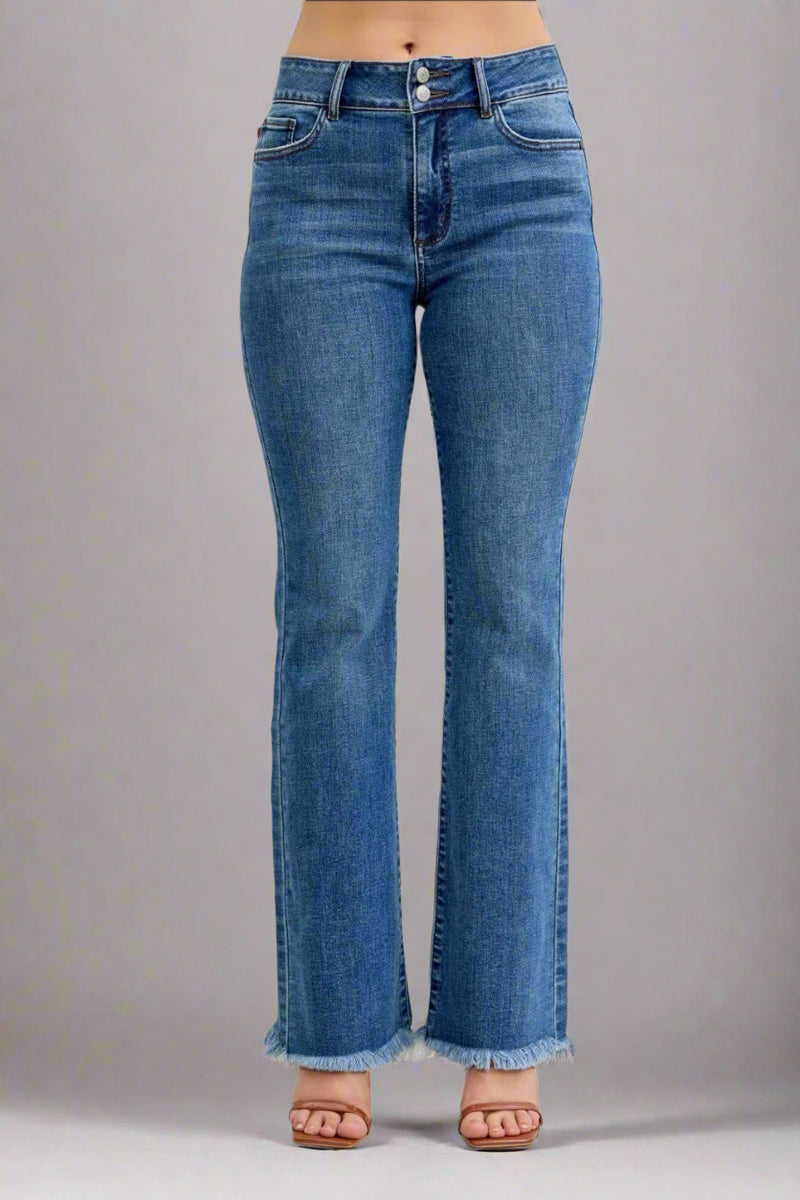 Flared blue jeans with distressed hem on a plain background.
