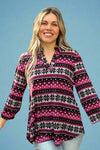 A womens lightweight, loose fit top with split v-neckline featuring a slight high-low hem, 3/4 sleeve length, and wintery snowflake print in black, magenta, and light grey.