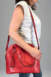 Model is carrying a large red bowler bag. 