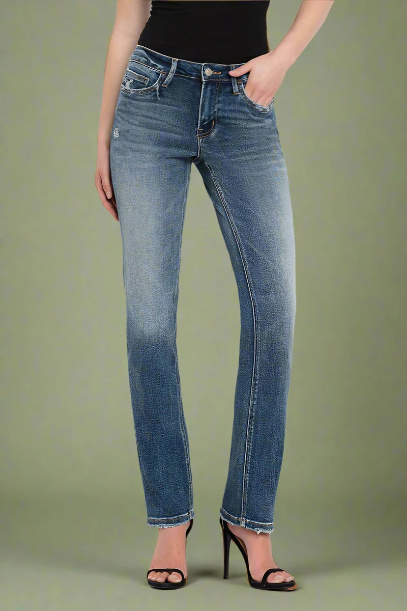 Person wearing blue straight leg jeans on a plain background.