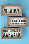 These inset wood box signs feature funny phrases.
