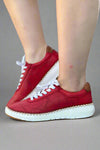 Red leather low top sneakers with a unique perforated leather detail and crisp white soles with contrasting tan stitching.