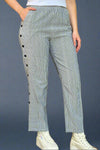 A pair of women’s casual pants featuring an elastic waist and relaxed straight leg with vertical stripes down the front and back with horizontal stripes and buttons along the side.