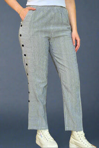 A pair of women’s casual pants featuring an elastic waist and relaxed straight leg with vertical stripes down the front and back with horizontal stripes and buttons along the side.