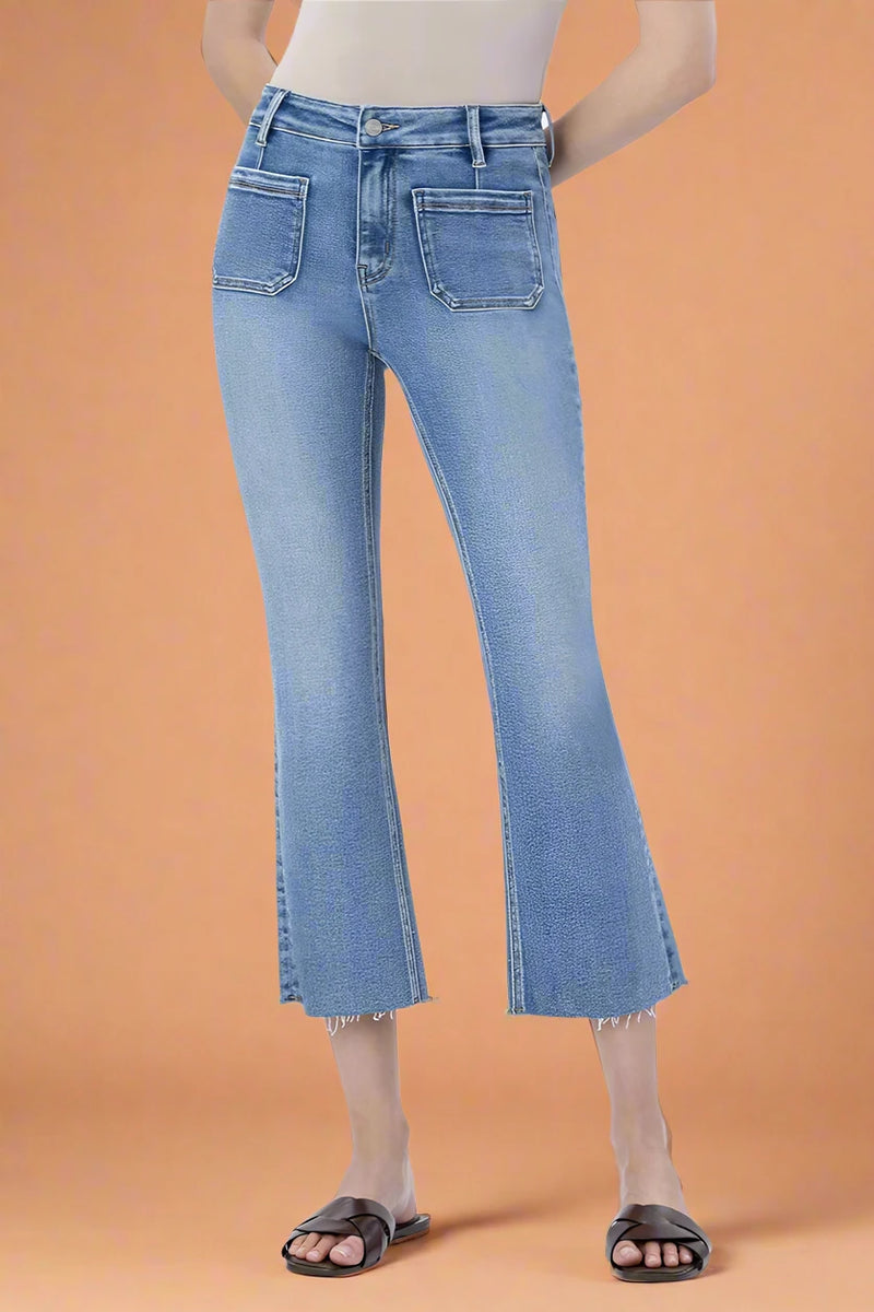 Person wearing light blue jeans on a plain background.