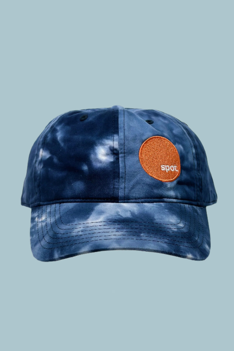 Blue tones tie dye cotton baseball cap with an embroidered Spot logo.