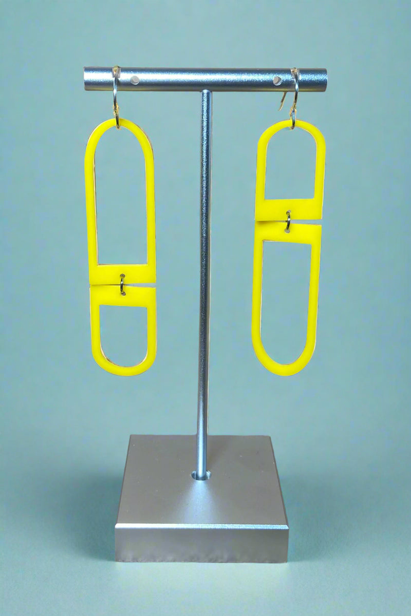 Yellow acrylic mismatched geometric shaped dangly earrings with silver hardware. 