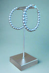 Brushed silver colored beaded bubble hoop earrings. 