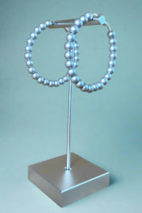 Brushed silver colored beaded bubble hoop earrings. 