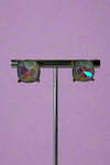 Large glass stud earrings with gold backings and a grey/opal inspired glass stone.