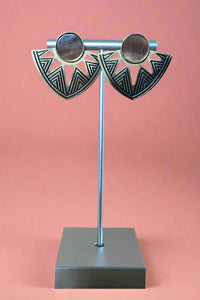 Inverted triangle shaped post earrings with a round shell and unique geometric etchings. 