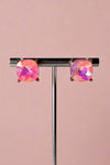 Light blush pink colored glass stud earrings with gold colored backings. 