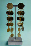 Gold colored hammered dangly earrings featuring a waterfall effect of different squares and circles. 