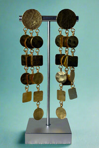 Gold colored hammered dangly earrings featuring a waterfall effect of different squares and circles. 