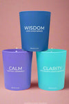 A trio of 100% soy votive candle in the scents Ocean Breeze, Grapefruit, or Sage & Lemongrass. Crystals are embedded in the wax.