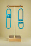 Blue acrylic mismatched geometric shaped dangly earrings with silver hardware. 