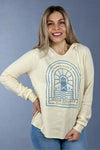 A Door County Hoodie in bone. This has a graphic featuring Door County coordinates and a lighthouse and a v-neckline. 