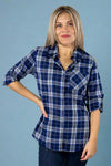 Model is wearing a blue tone plaid button up shirt with a front pocket and sleeves that can be buttoned to 3/4. 