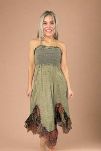 Model is wearing a smocked top olive green boho inspired midi dress with a shark bite style ruffle hem.