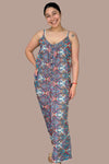 A women’s lightweight breathable polyester button front jumpsuit with bohemian paisley print in blues, red, and pink featuring spaghetti straps, pockets, and long flowy pants.