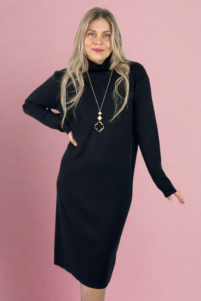 A women’s black midi sweater dress featuring a relaxed fit, turtle neck, and long sleeves.