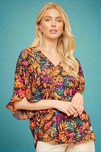A womens flowy ruffle sleeve blouse with babydoll cut and v-neckline featuring a tropical fauna print in orange, magenta, and teal.