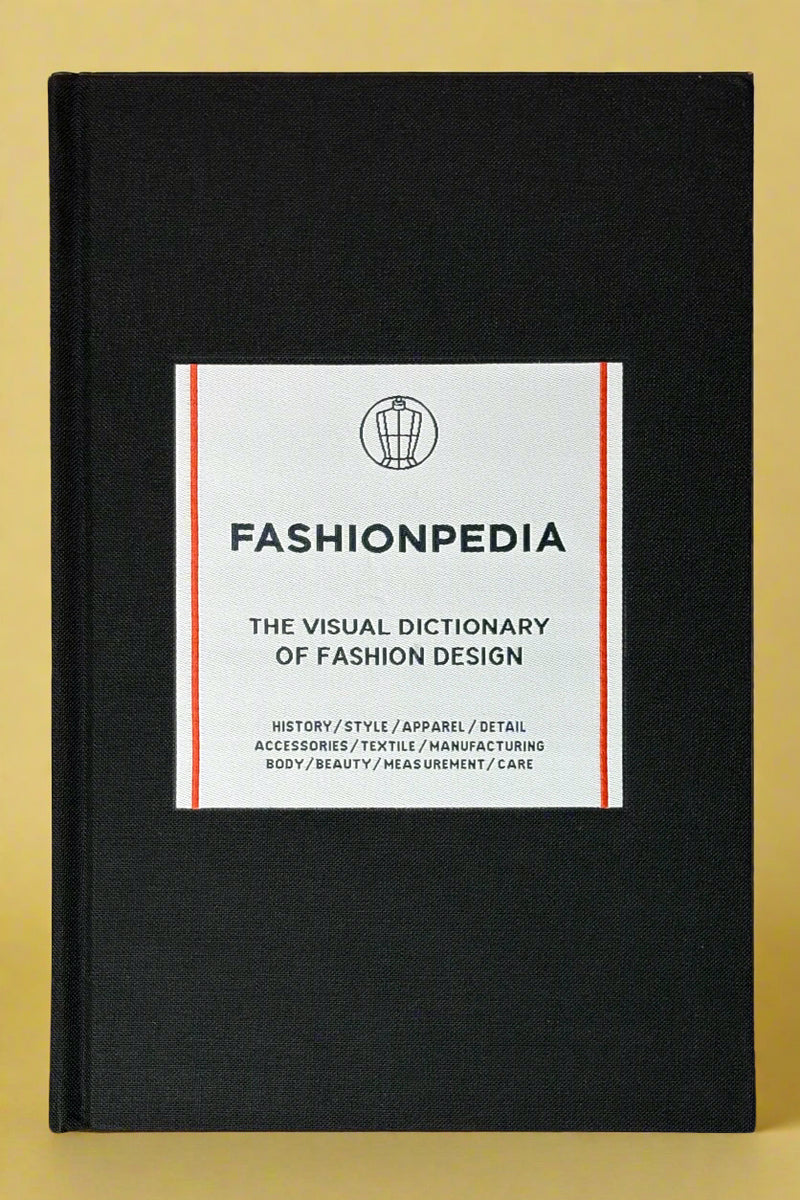 A black hardcover book titled "Fashionpedia".