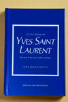 Small bright blue hardcover book titled "Little Book of Yves Saint Laurent".
