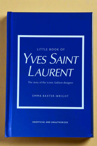 Small bright blue hardcover book titled "Little Book of Yves Saint Laurent".
