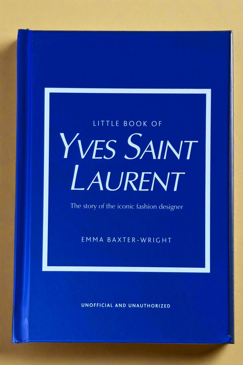 Small bright blue hardcover book titled "Little Book of Yves Saint Laurent".