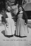 A card with a black and white image of an old woman and a nun that says “You know you’re getting old….”