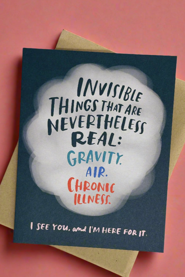 A navy blue greeting card with a white smoke cloud and text in the cloud that reads ‘Invisible things that are nevertheless real: gravity. air. chronic illness. I see you, and I’m here for it.’