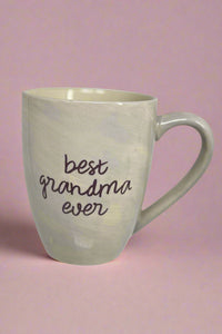 An iridescent white coffee mug with ‘best grandma ever’ written on the front.