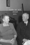 A card with a vintage black and white photo of a couple and says “life is all about ass.”
